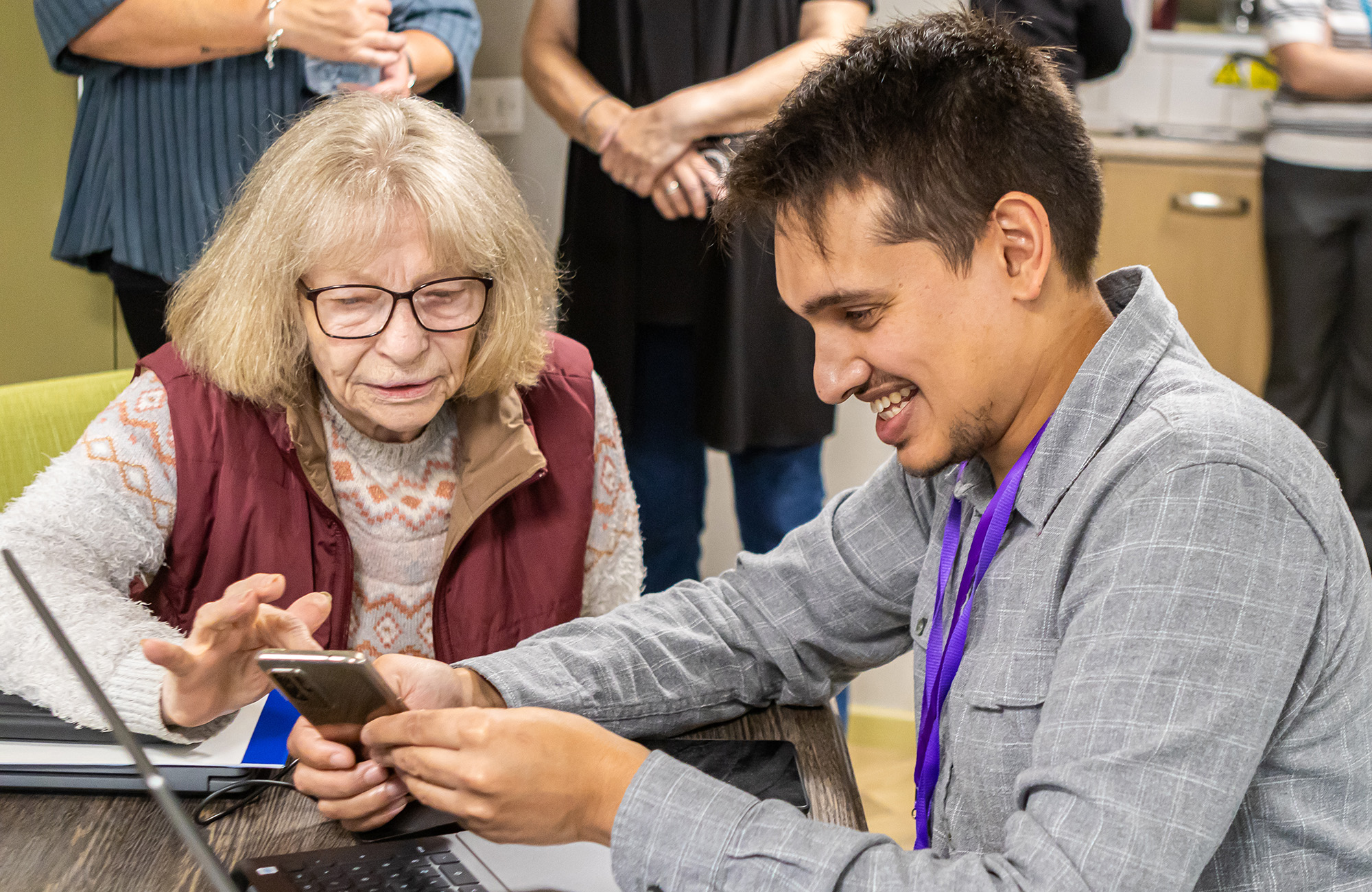 Man and a woman talking whilst looking at a phone