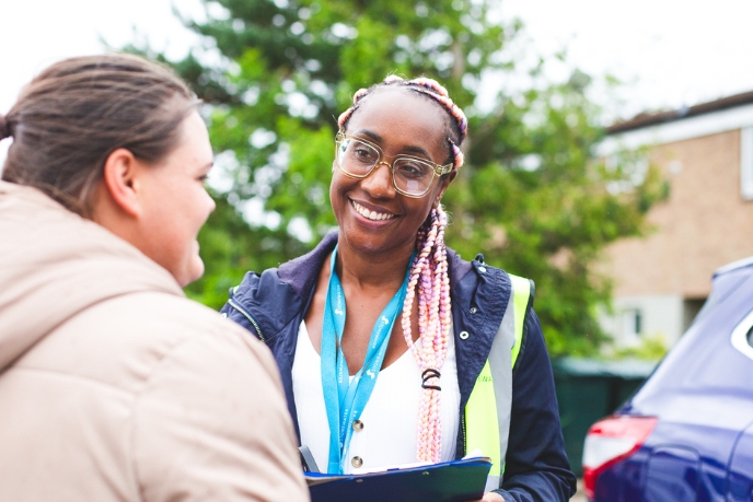 Two people smiling having a conversation