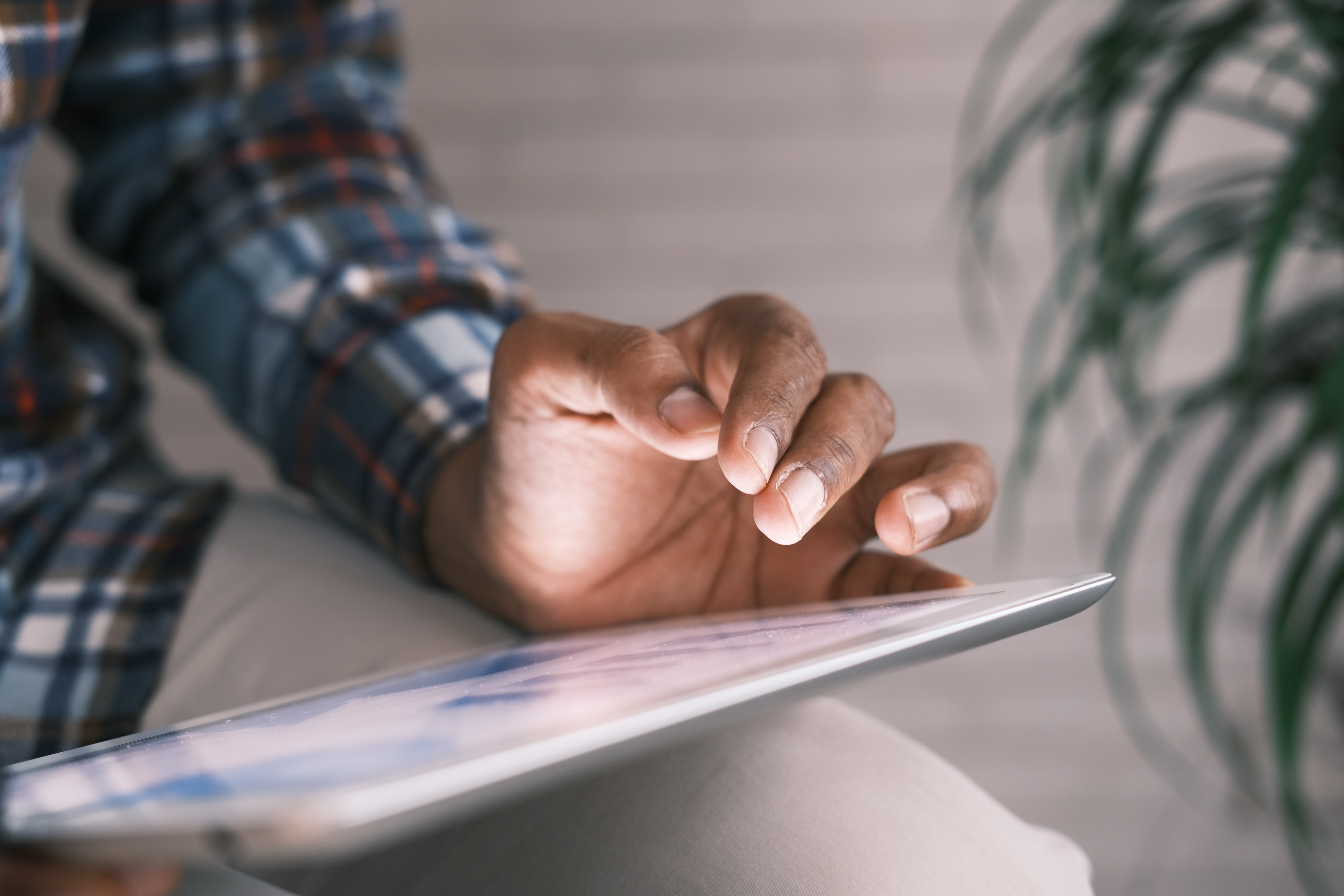 Close-up of man browsing on tablet device