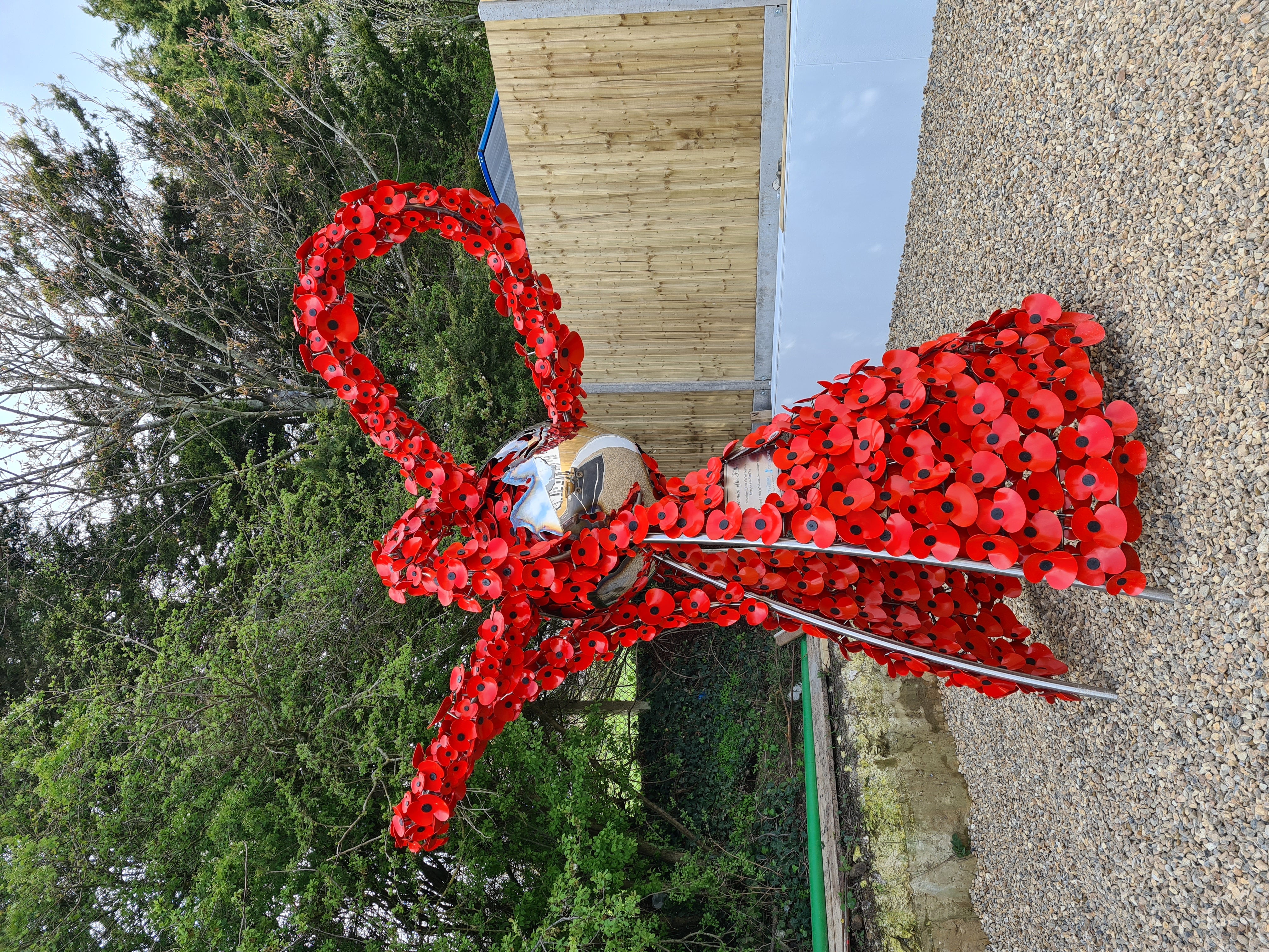 Angel sculpture made of red poppies titled Ascension of the Fallen 