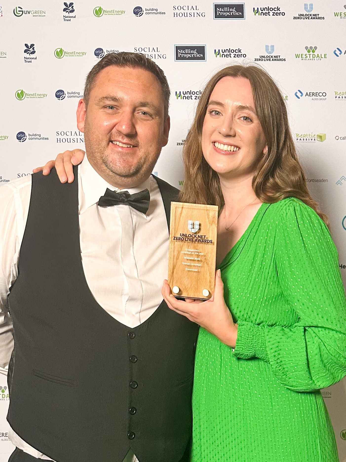 Image of two Stonewater colleagues holding an award