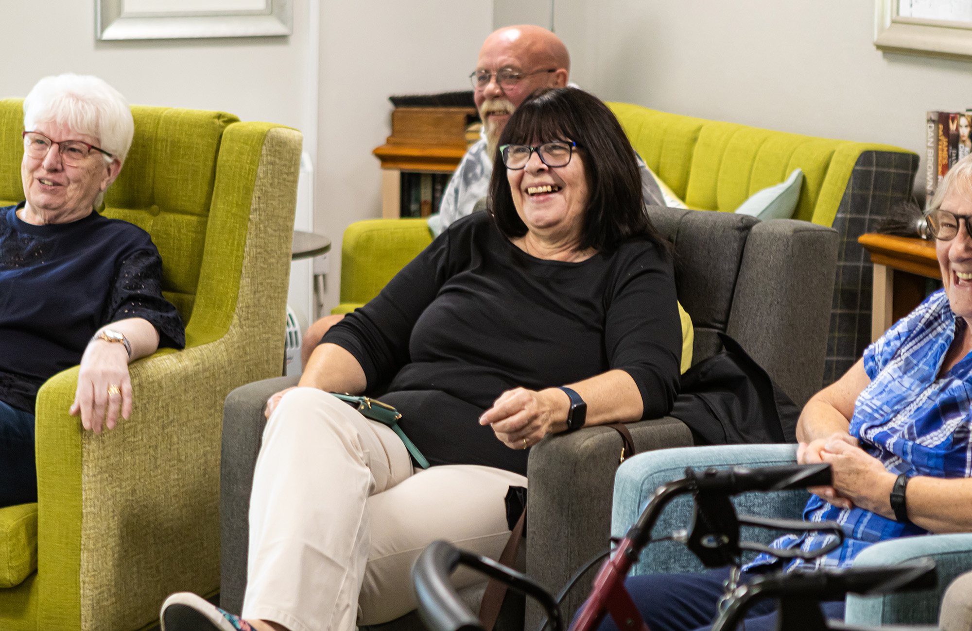 Group of people sitting in chairs smiling