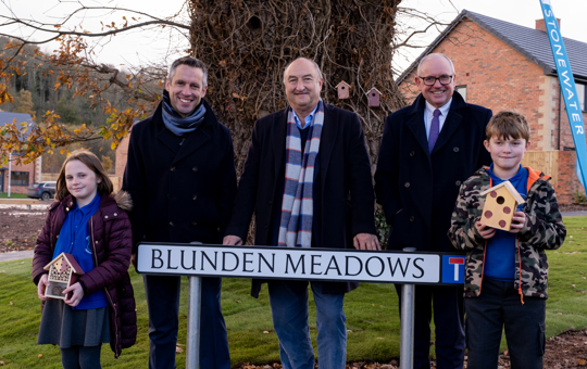 2 Ewyas Harold Primary School students and 3 Stonewater employees with Blunden Meadows street sign