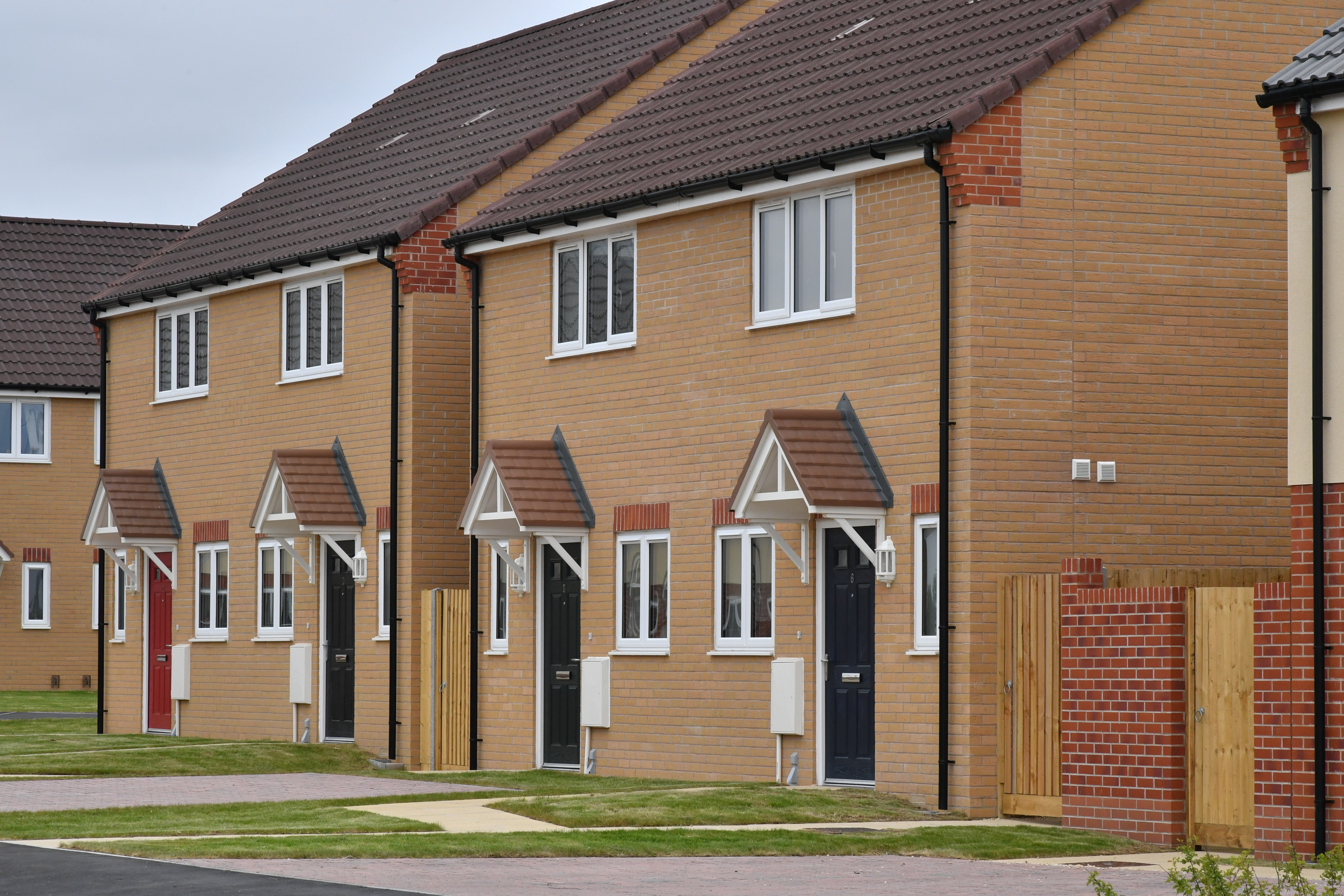 Row of new-build homes with black front doors