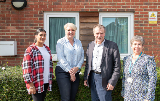 4 people stood outside a Stonewater supported living scheme