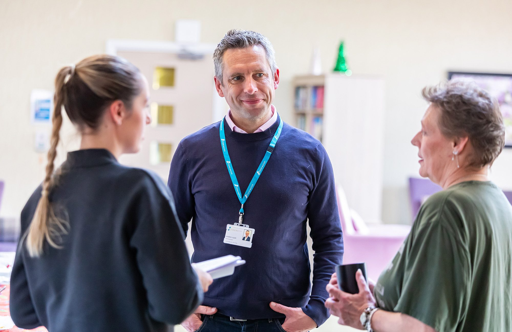 Two women and a man talking