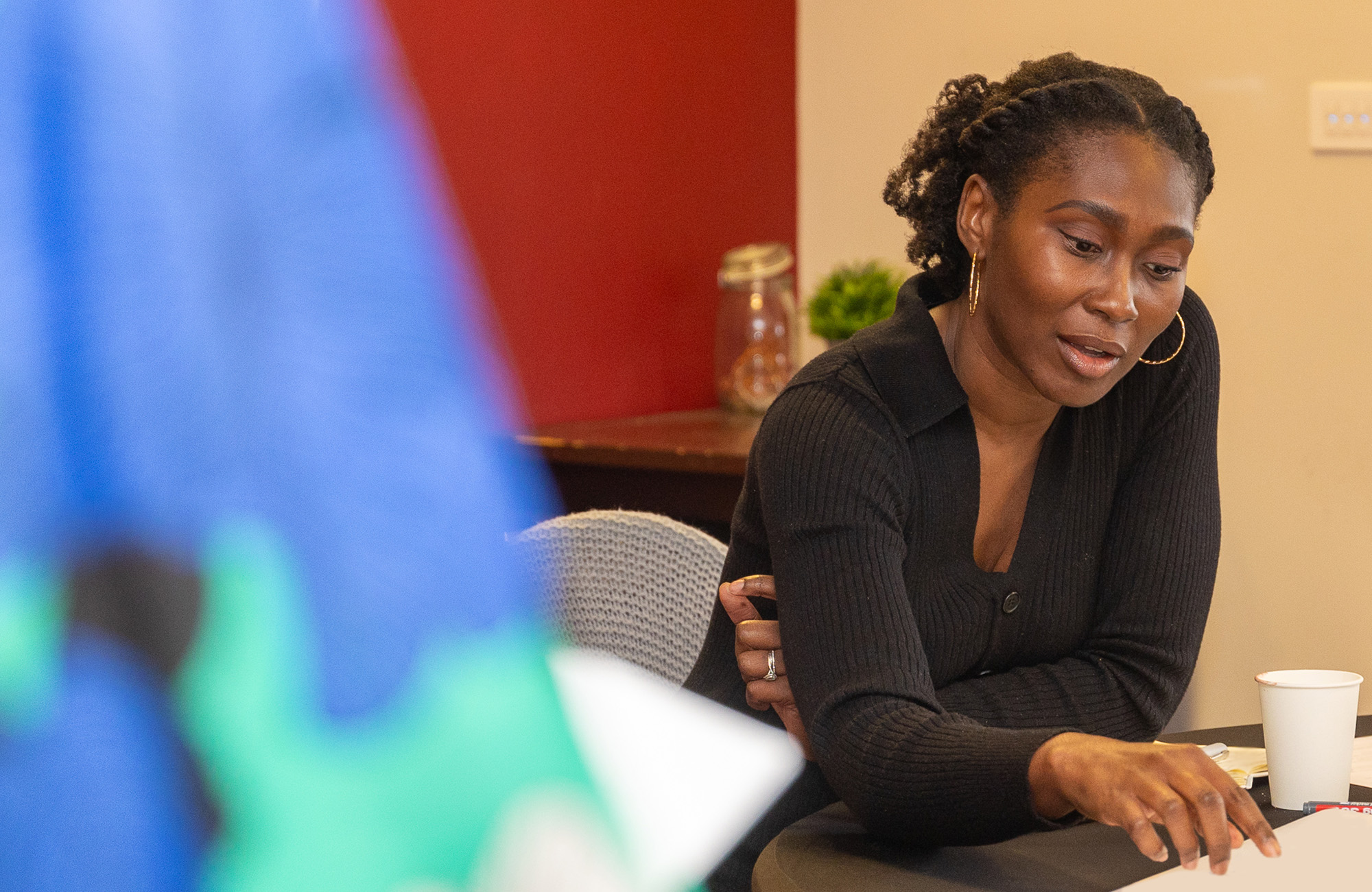 Woman sat pointing at a piece of paper